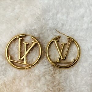 Louis Vuitton Louise large gold toned LV logo hoop earrings.